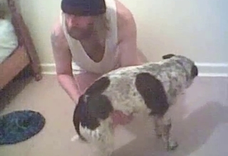 Beanie-wearing dude is fucking his dog